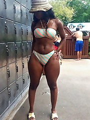 A large black mom in a bathing suit,..